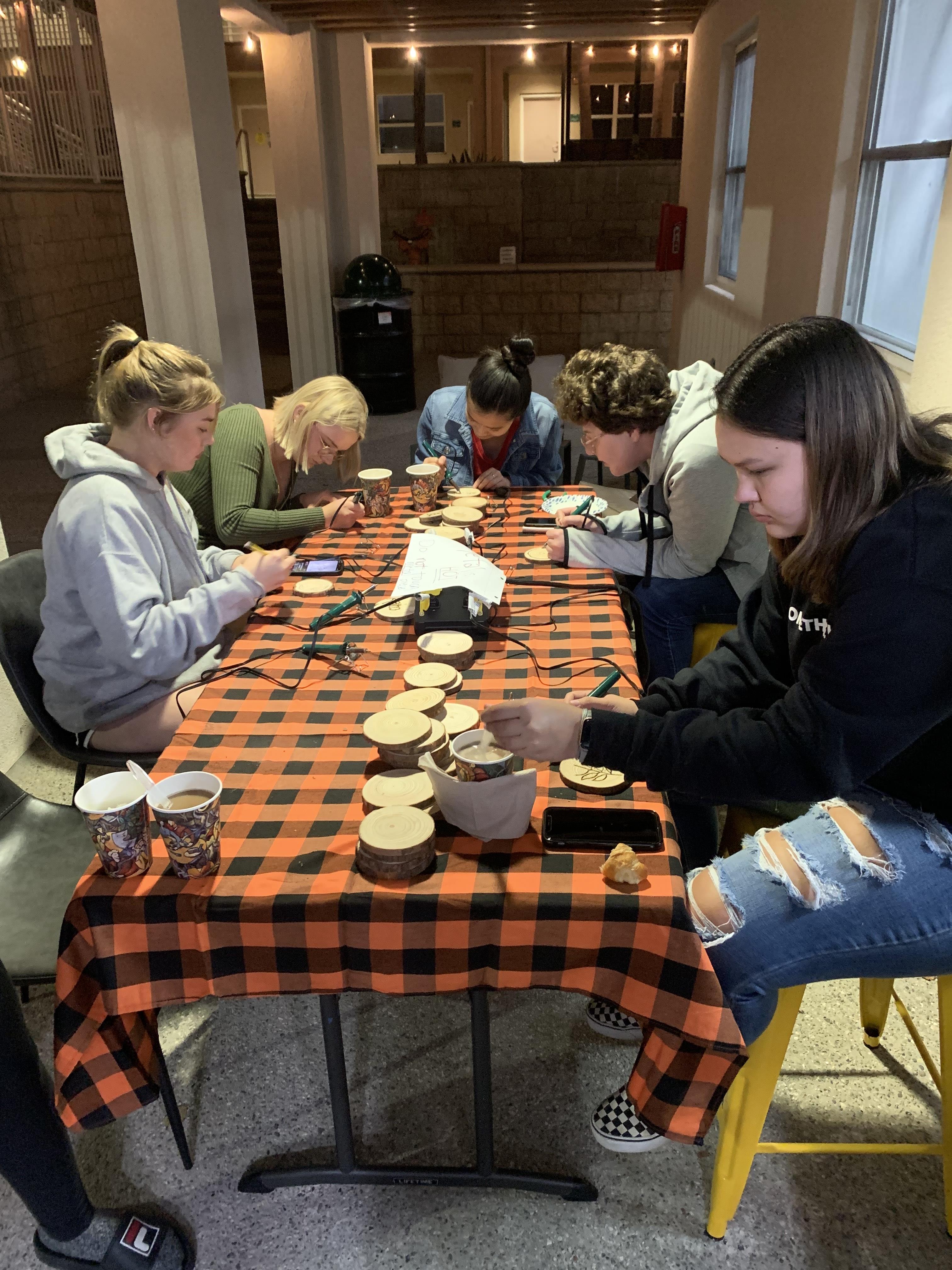 Students burning coasters at Coffeehouse night
